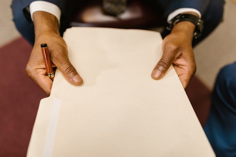 Close-Up Shot of a Person Holding a Document