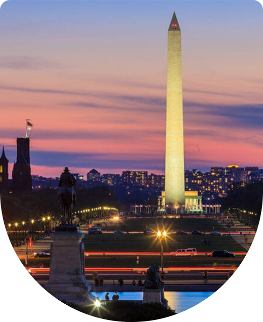 Washington Monument at sunset with city lights