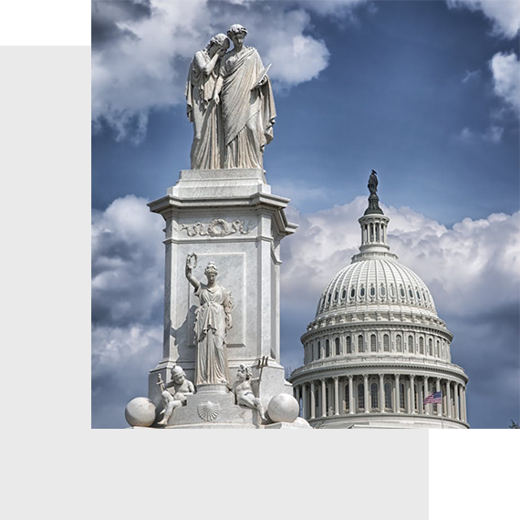 US Capitol dome and Peace Monument statues.